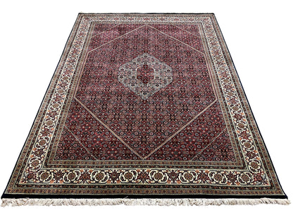 Rectangular Bidjar rug with a red ornamental pattern, central medallion, and fringes
