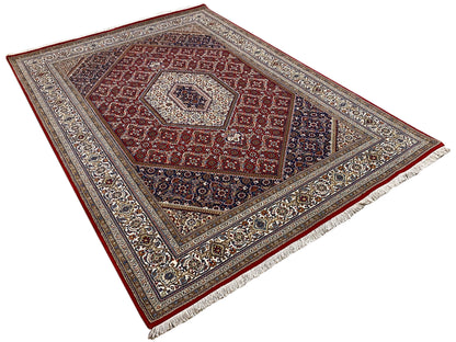 Square rug with a border, a red central medallion, and a blue-and-beige pattern