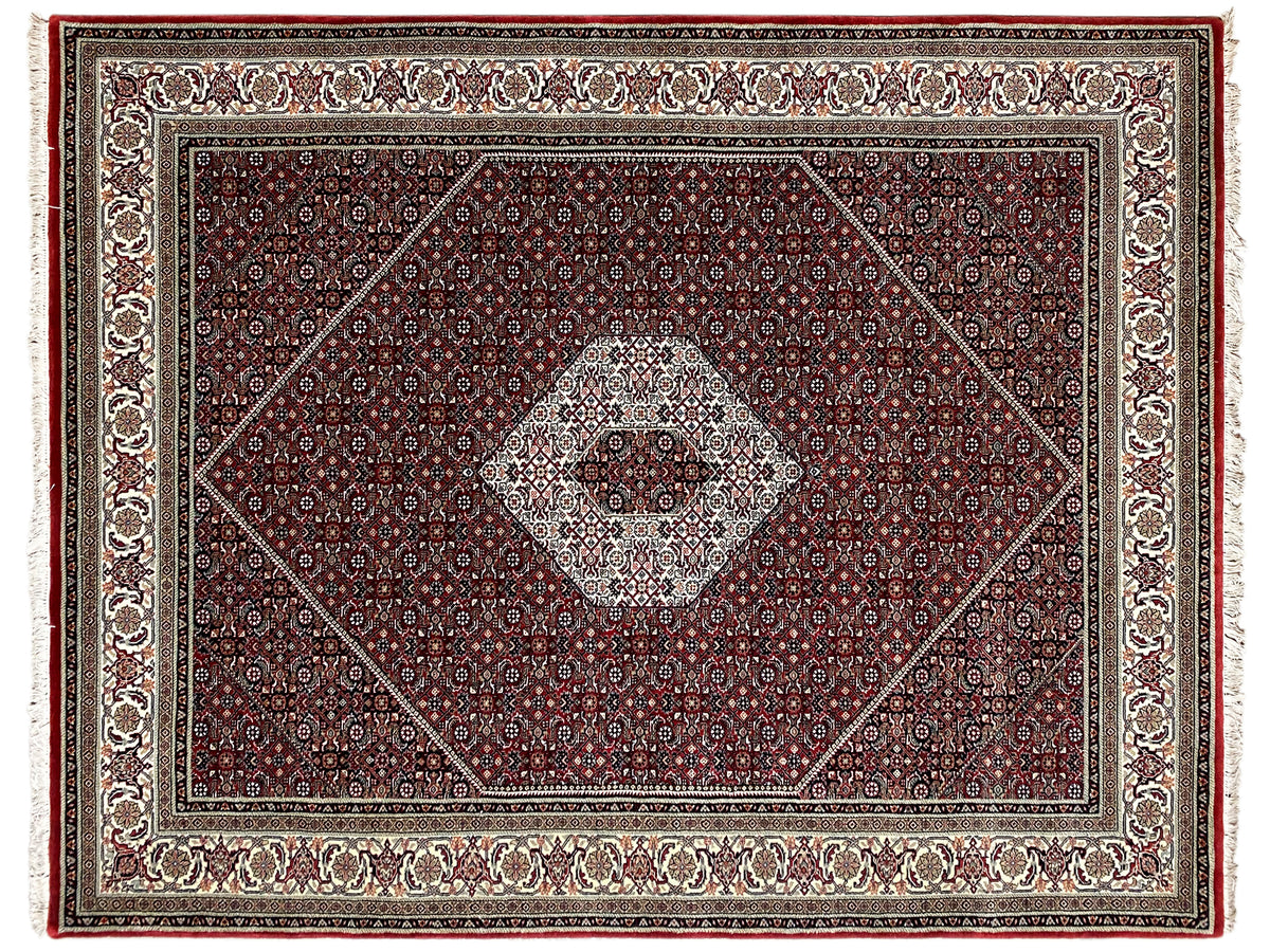 Bidjar rug viewed from above: reddish-brown central medallion with a fine cream-colored border