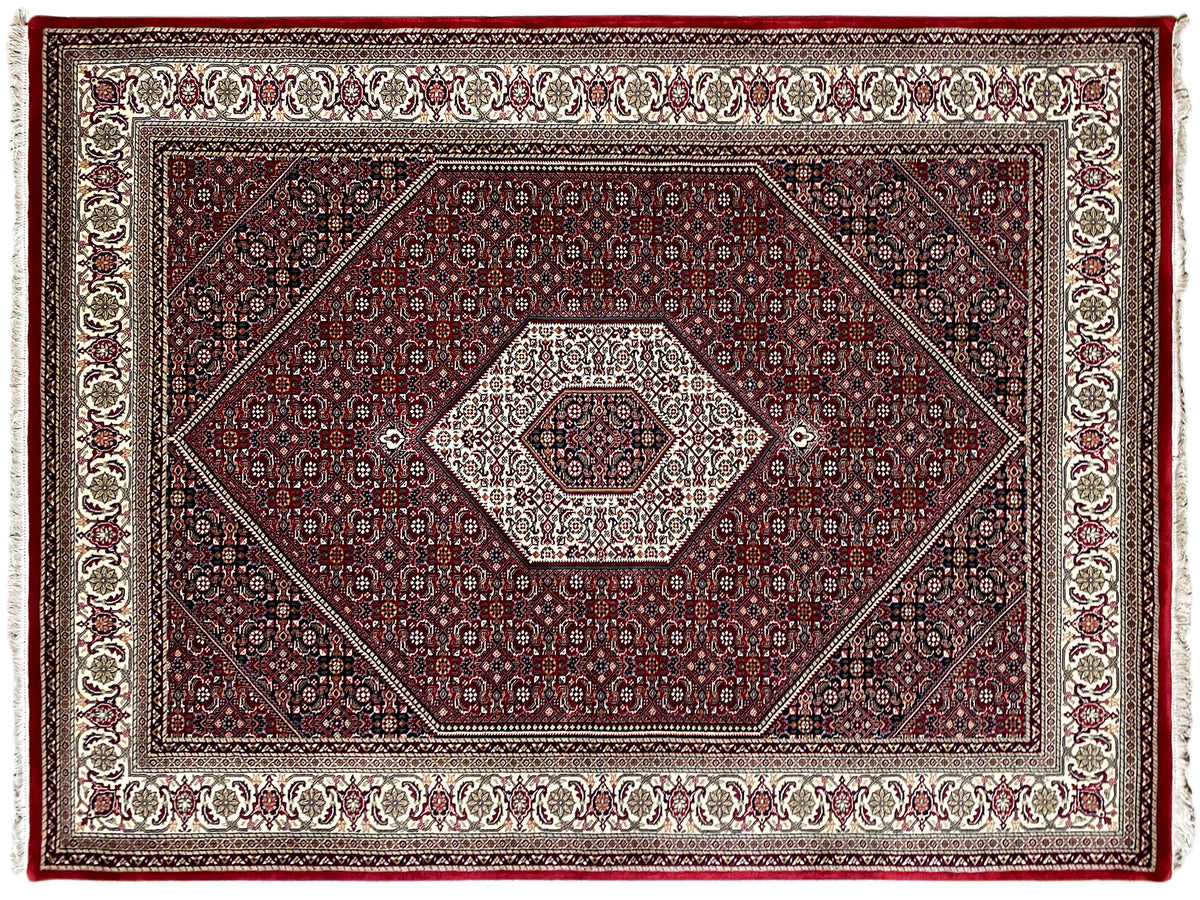 Red Bidjar rug with a geometric pattern and border in cream and dark blue