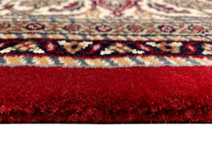 Reddish-brown carpet with dense pile and a multicolored border around the edge