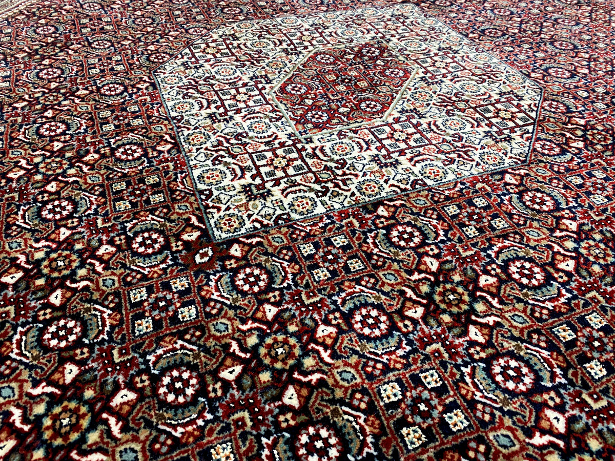 Rug with numerous small motifs in red, blue, cream, and dark blue