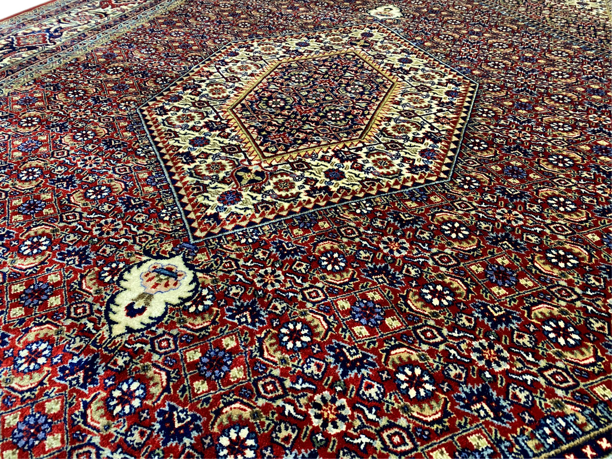 Bidjar rug close-up: blue and yellow accents in the red ornamental pattern