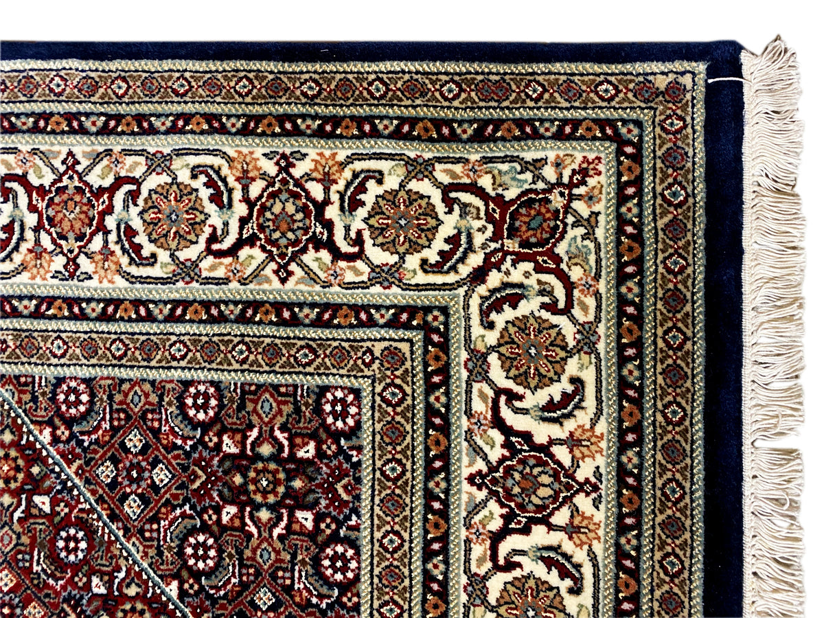 Rug with a decorative border and tassels along the edge