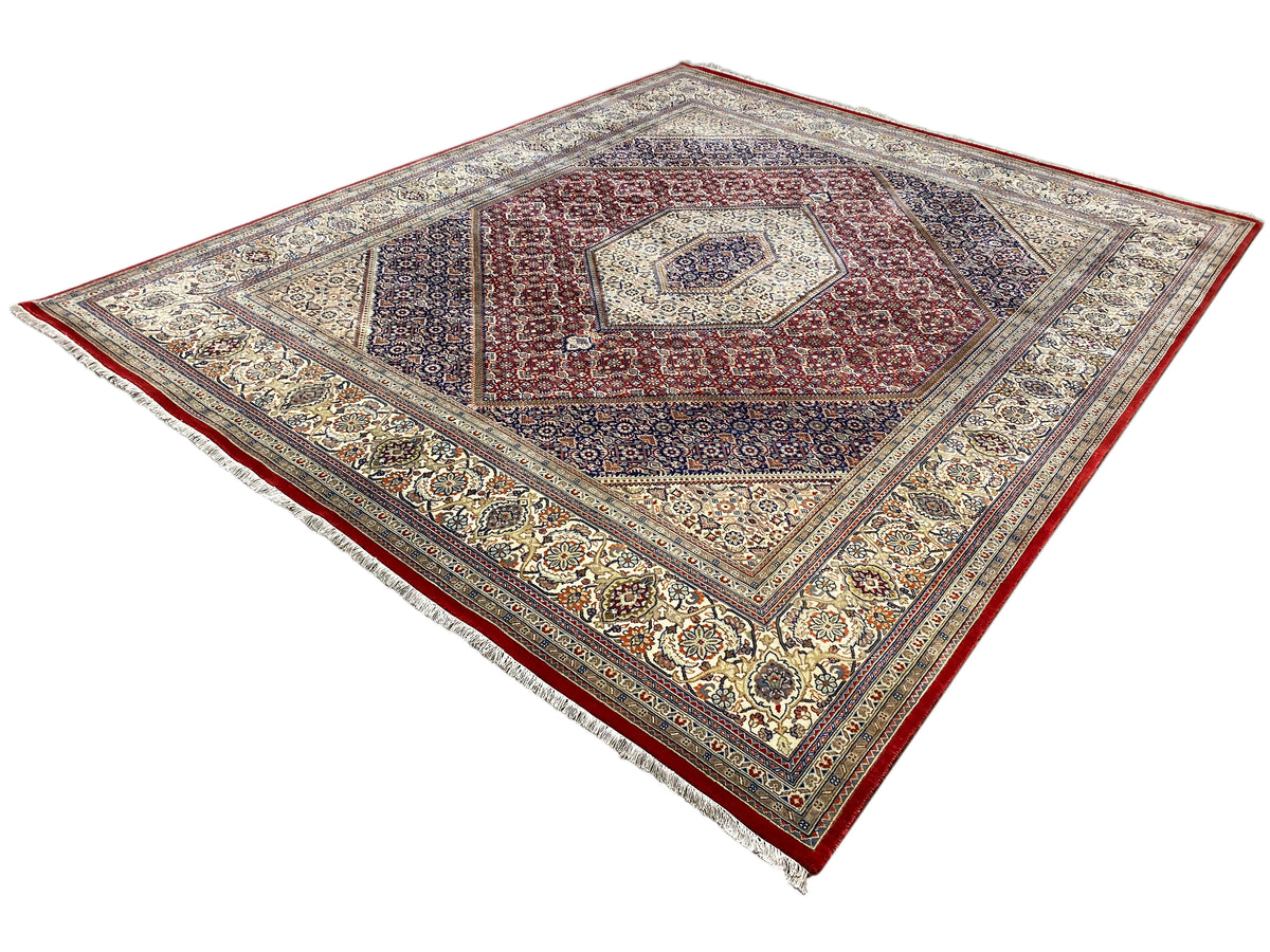 Bidjar rug with a geometric quadrilateral medallion in red, blue, and cream, viewed from the corner