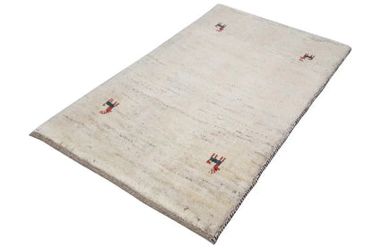 Gabbeh rug 96x60 cm: beige rug with red animal motifs, slightly angled