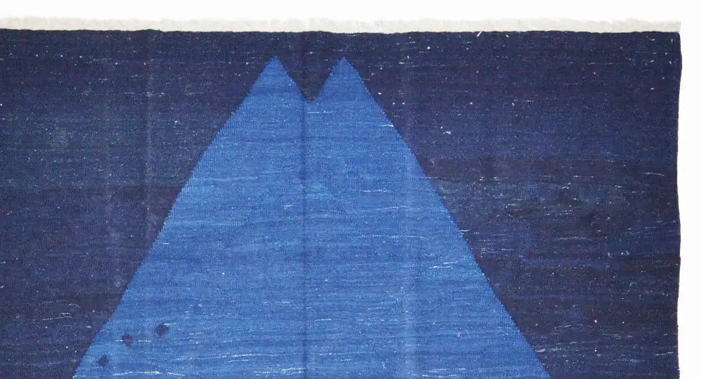 Close-up: blue diamond pattern on a dark blue carpet with subtle gradients