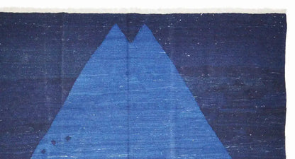 Close-up: blue diamond pattern on a dark blue carpet with subtle gradients