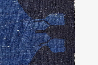 Detail of the woven surface: blue pattern on a dark blue carpet background