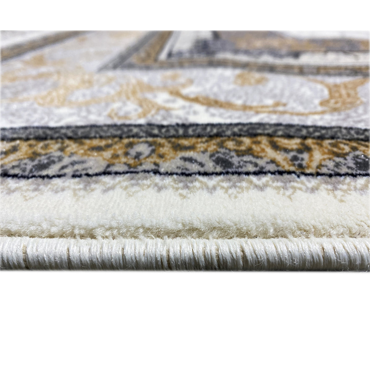 Rug edge with ornamental border and fringes, cream-colored base surface