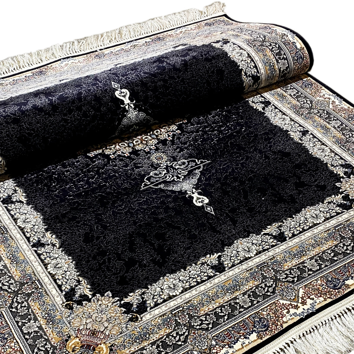 Black rolled-up carpet with ornaments, borders, and medallion design