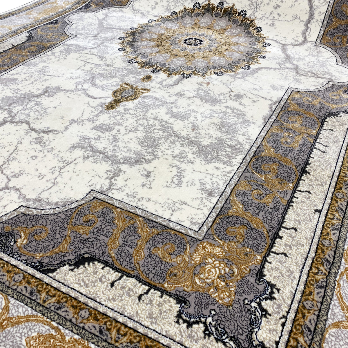 Carpet detail: circular medallion in gold and dark tones on a light background