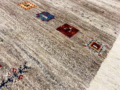 Close-up of a Gabbeh runner: mottled texture with several colorful squares and decorative elements.