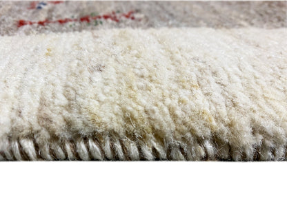 Gabbeh runner rug with a light, fluffy pile and dark fringe trim.