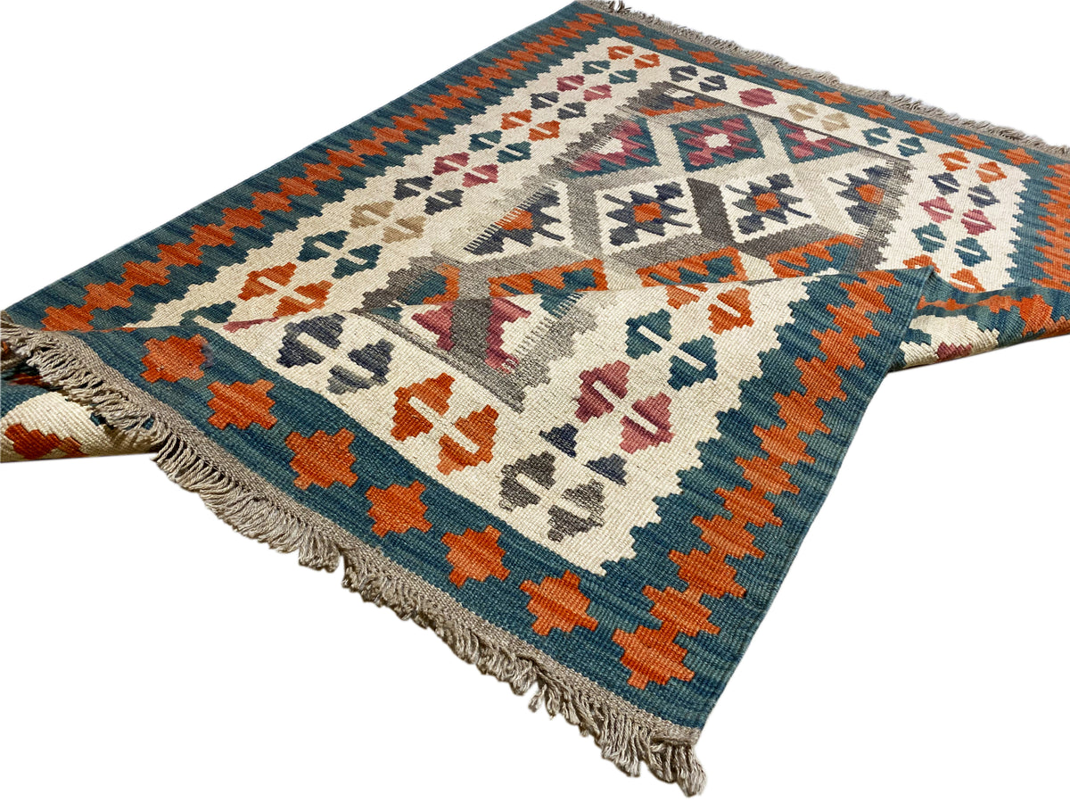 Kilim rug with colorful geometric patterns and a wide border, fringes along the edge