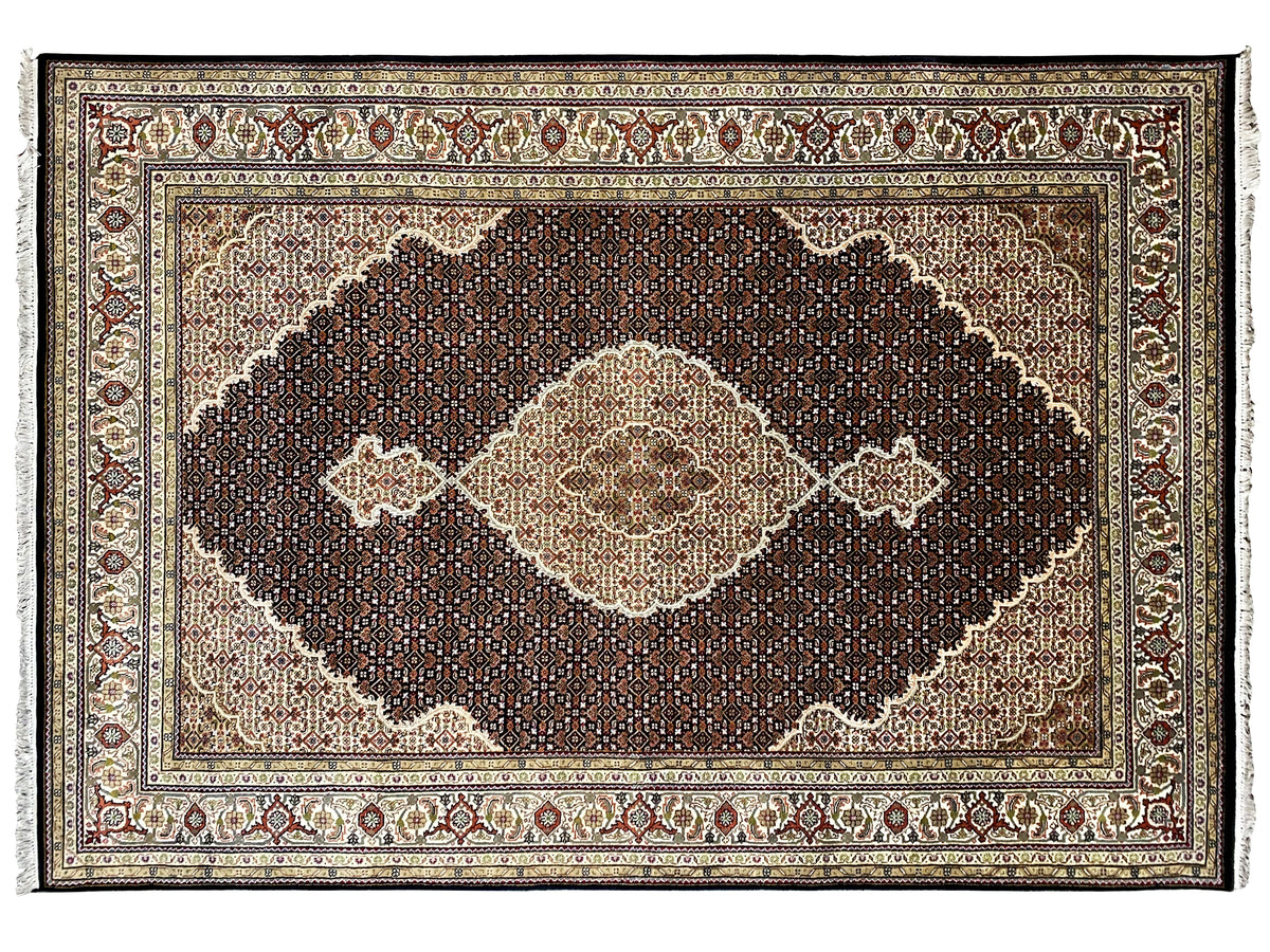 Brown Indo-Tabriz rug with a dark ornamental field and light diamonds, close-up view