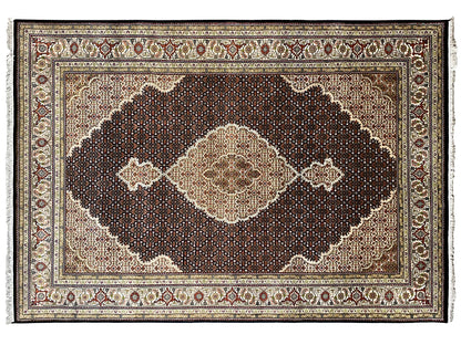 Brown Indo-Tabriz rug with a dark ornamental field and light diamonds, close-up view