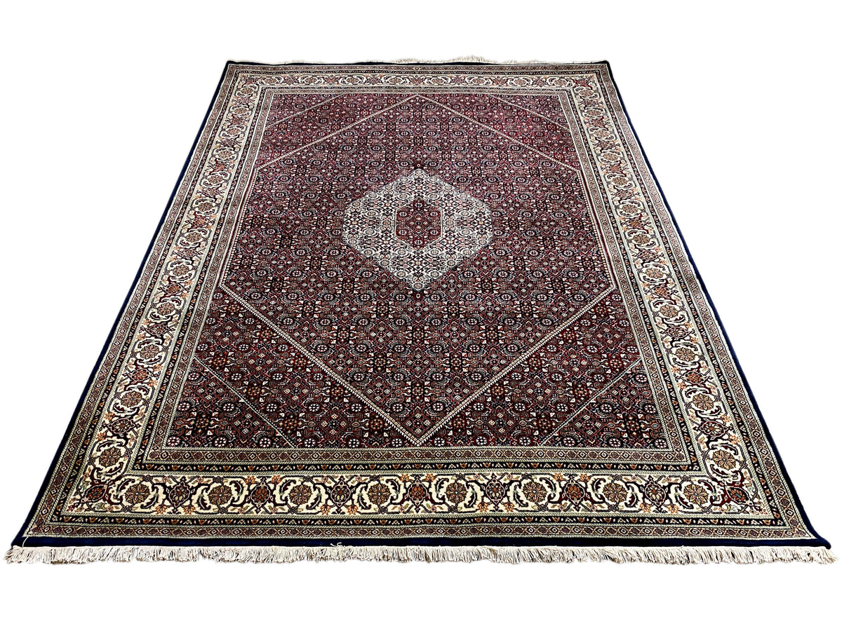 Top-down view of a rug with a medallion, borders, and a reddish-brown background