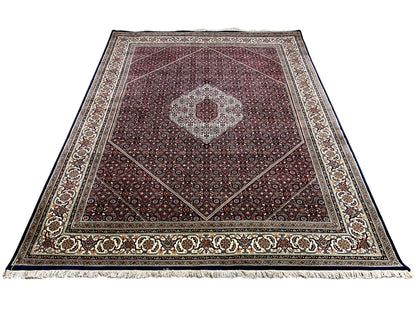 Top-down view of a rug with a medallion, borders, and a reddish-brown background