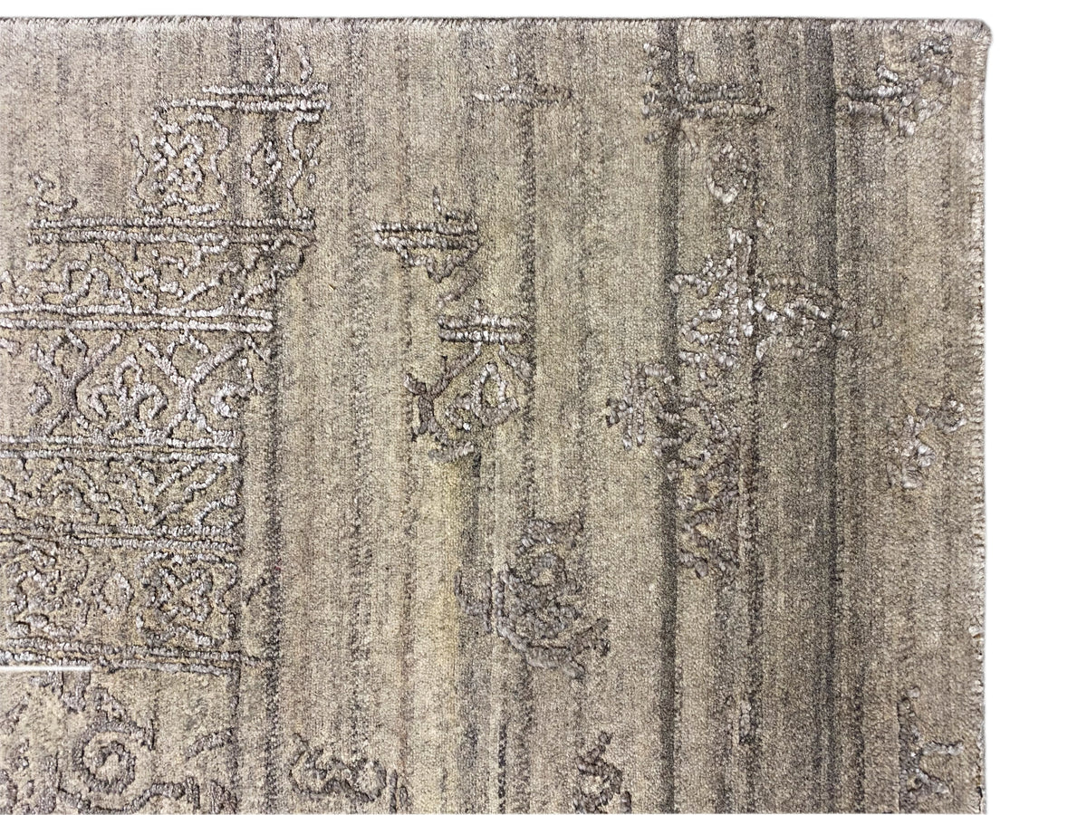 Detail view: Gray designer rug with light ornaments and an aged texture