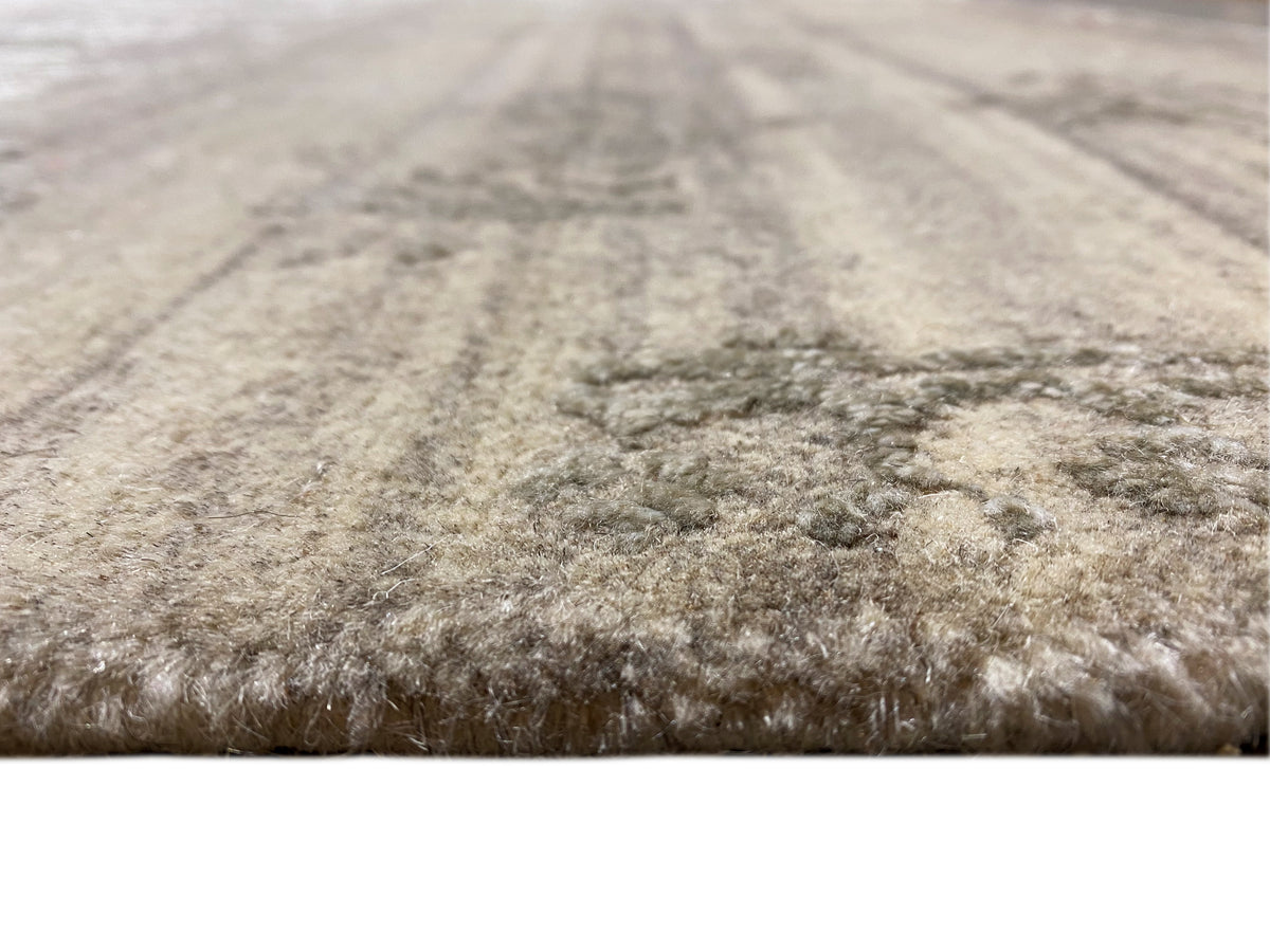 Beige carpet surface with a short pile and a mottled, irregular pattern