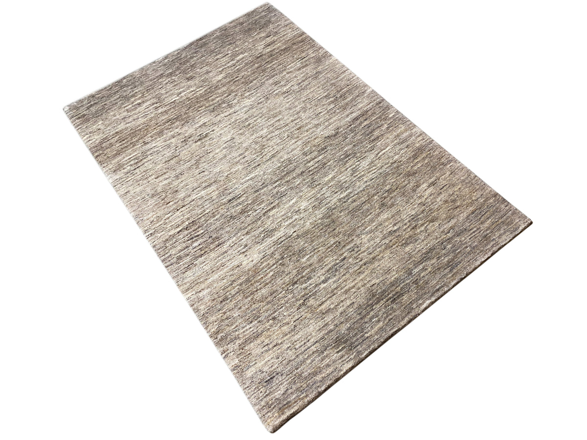 Rectangular Gabbeh rug, placed slightly askew, gray-beige mélange with a fine texture