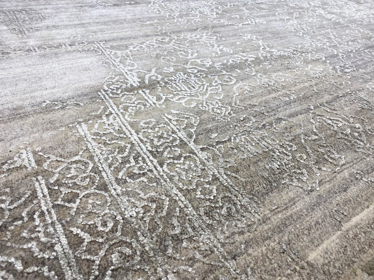 Beige rug with a detailed ornamental relief of light pattern lines