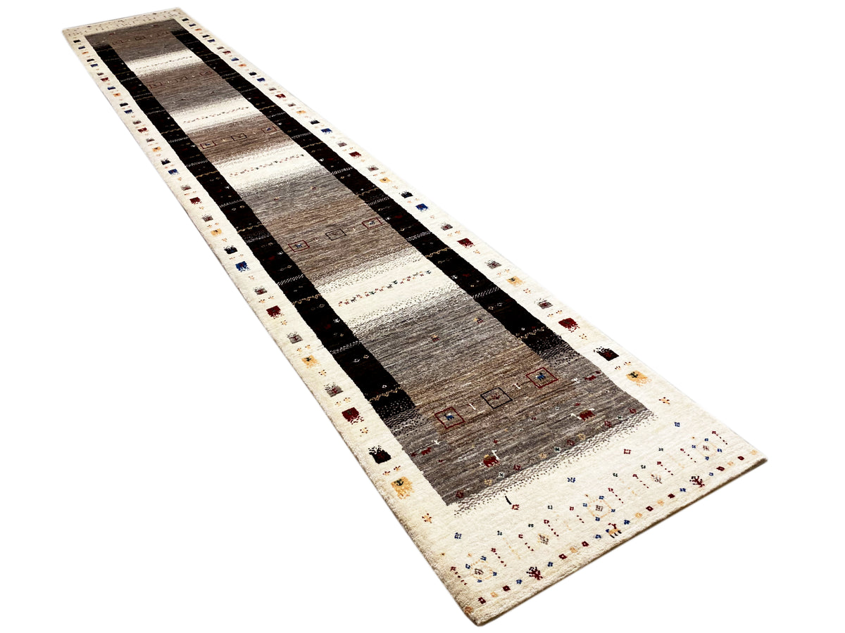 Narrow Gabbeh runner in a diagonal layout: white, gray, and black with decorative bands