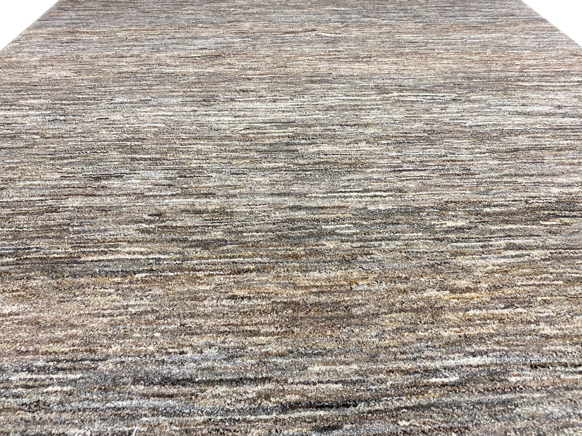Close-up: 243x168 rug with a mottled gray-brown linear pattern and fine pile texture.
