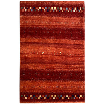 Gabbeh rug with wide reddish stripes and a multicolored border at the ends