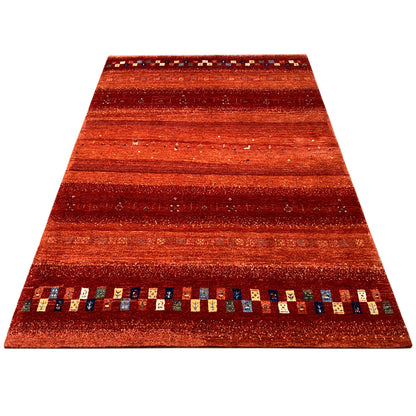 Gabbeh rug with a reddish stripe pattern and multicolored decorative border