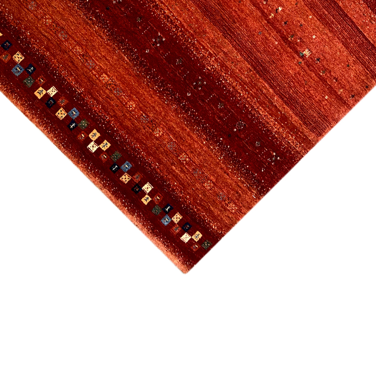 Gabbeh rug with a reddish striped pattern and multicolored border at the corner detail