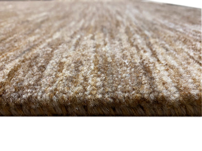 Gabbeh rug detail: brown-beige pile, compact short-pile texture at the edge