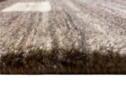 Low-pile surface of a beige-gray Gabbeh rug, richly detailed pile