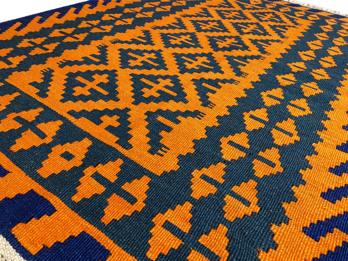 Kelim rug with orange-yellow and dark blue zigzag patterns, close-up