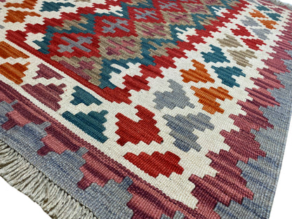 Colorful Qashqai kilim rug with a geometric pattern in red, blue, green, and beige