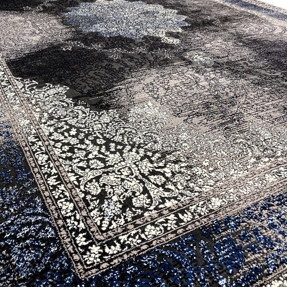 Oriental rug 160x230 close-up: blue-black ornamental pattern, textured pile