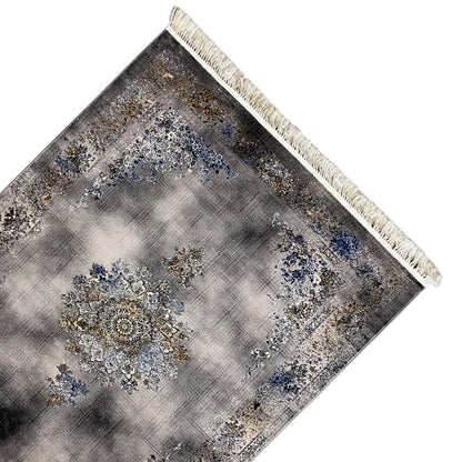 Medallion rug 160x230 cm close-up: gray texture with a blue medallion and gold accents, fringes