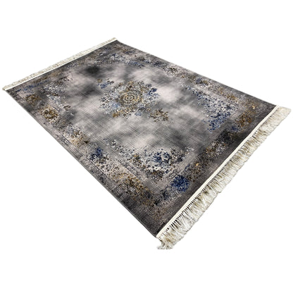 Rectangular rug with a medallion pattern in gray, blue, and gold, with fringes along the edges