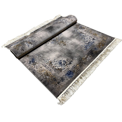 Rectangular rug with a medallion design and floral patterns, gray-blue, gold accents, fringe