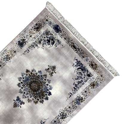 Medallion rug with a central ornament, blue-and-gold pattern, and fringes