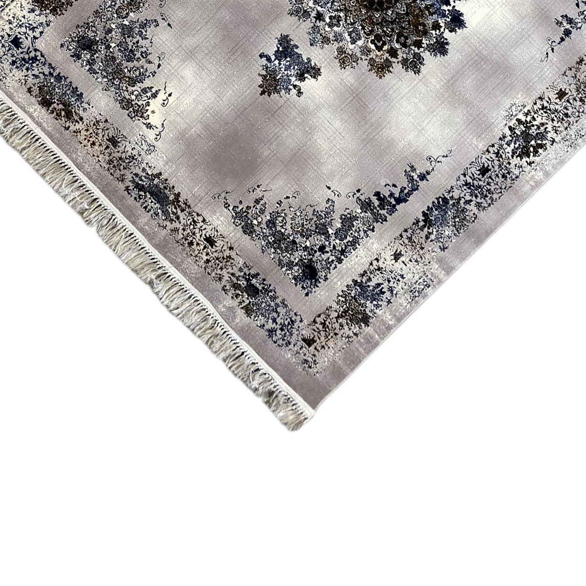 Corner view of a medallion rug with border, blue-and-gold motifs, and fringes