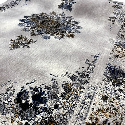 Medallion rug with a light background, dense blue and gold ornaments