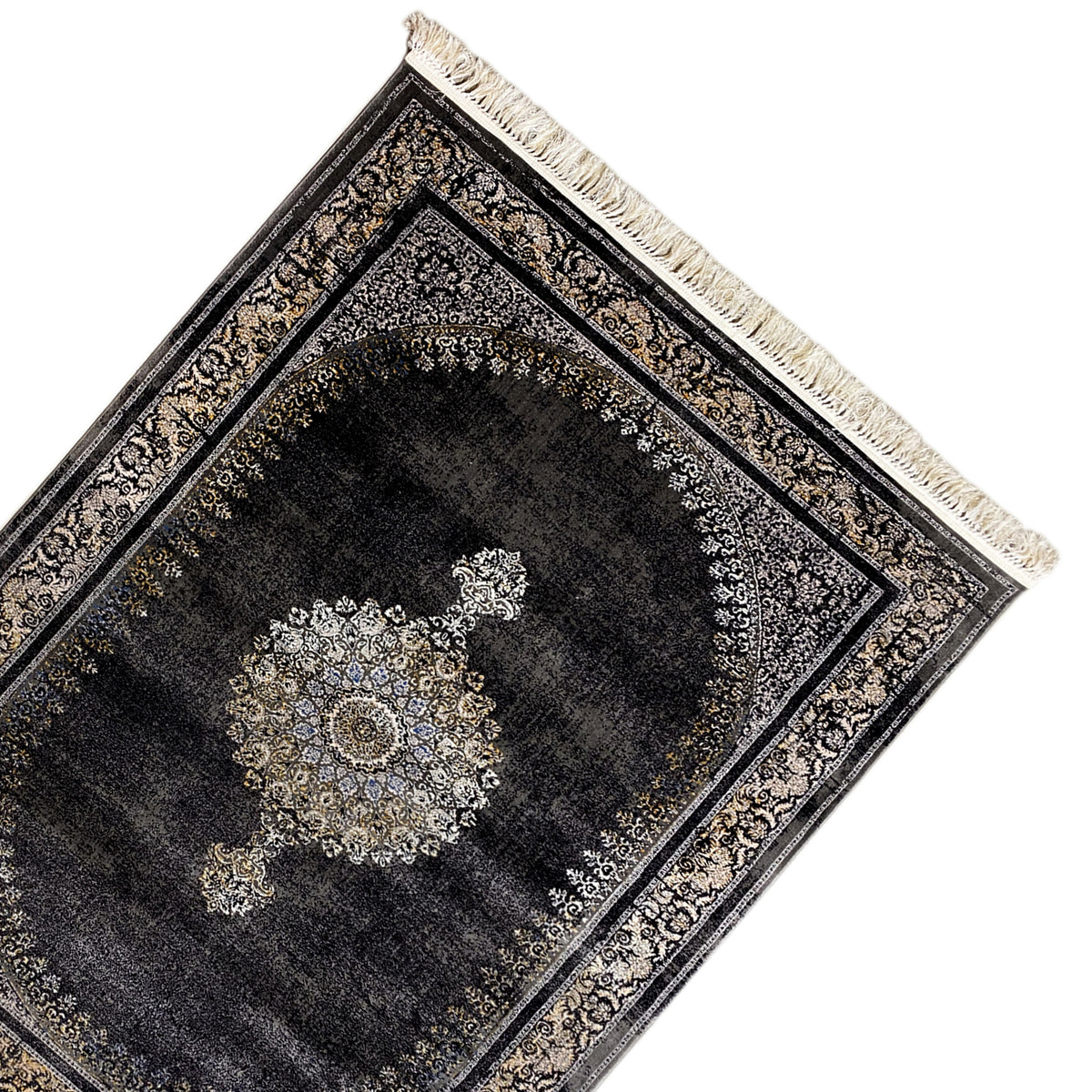 Medallion rug, laid at an angle: dark pile with a decorative medallion, fringes