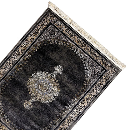 Medallion rug, laid at an angle: dark pile with a decorative medallion, fringes