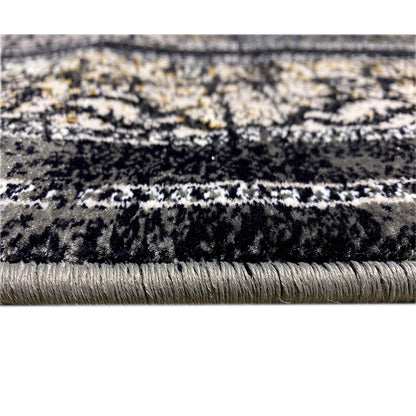 Detailed view: dark pile with a fine pattern and short fringes along the rug’s edge