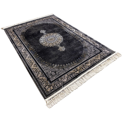 Medal rug laid at an angle: dark background, medallion design, fringes at the corners