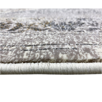 Close-up of carpet edge: fringe and pattern line, silver-gray