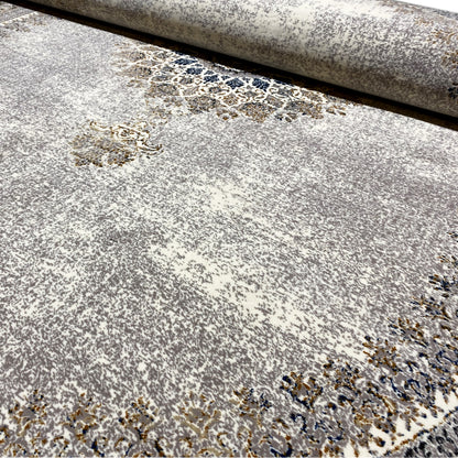 Close-up of the vintage rug: fine pile with patterned, grainy color accents