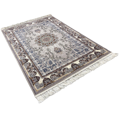 Nain rug laid flat with a blue background, central medallion, and fringes